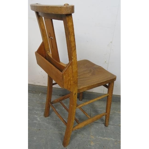 814 - A turn of the century elm and beech ecclesiastical prayer chair, having pierced crucifix decoration,... 