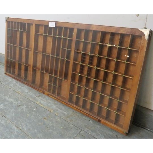 818 - An antique walnut printer’s tray/wall mounting display shelf, the glass front enclosing an array of ... 