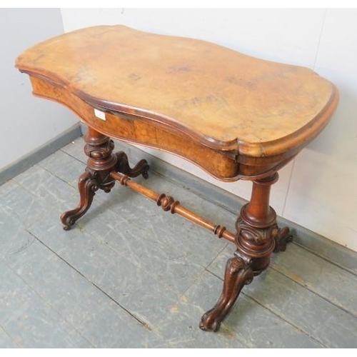 823 - A Victorian figural walnut card table, the serpentine rectangular top with inverted rounded corners,... 