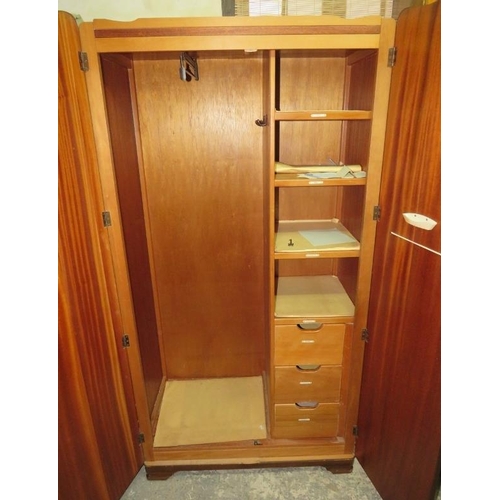 827 - An Art Deco Period burr walnut double wardrobe by Lebus, the twin doors opening onto a fitted interi... 