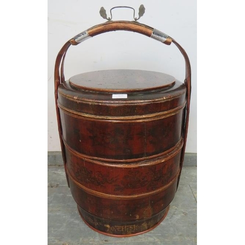 829 - An early 20th century Chinese bamboo wedding basket, of three stacking sections with bentwood carry ... 