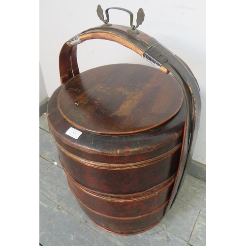 829 - An early 20th century Chinese bamboo wedding basket, of three stacking sections with bentwood carry ... 