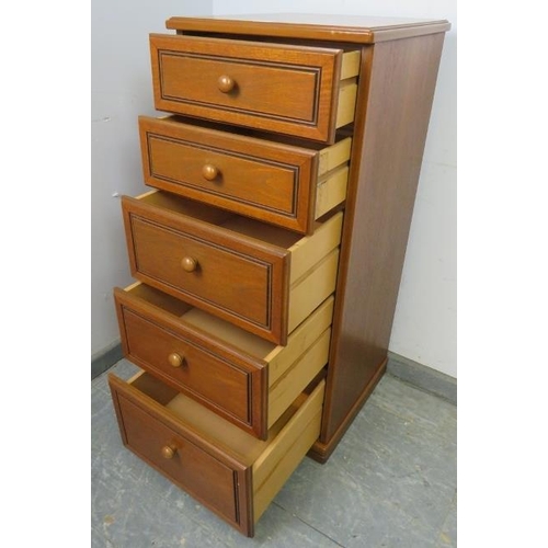 832 - A vintage narrow teak chest of five graduated drawers with turned wooden knob handles, on a plinth b... 