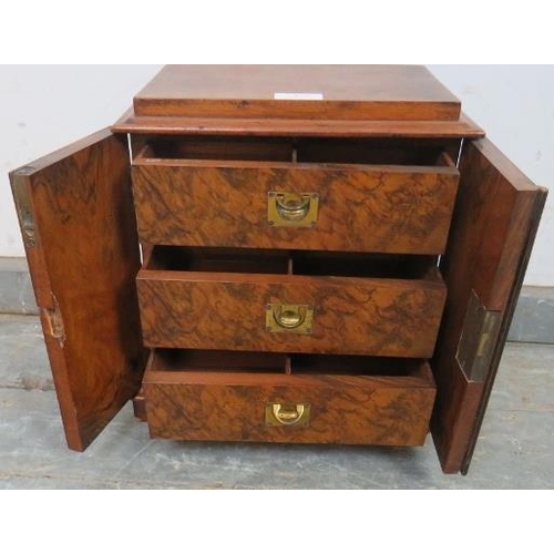 852 - A Victorian figured walnut table top cabinet, the twin doors with ebony and satinwood inlay, opening... 