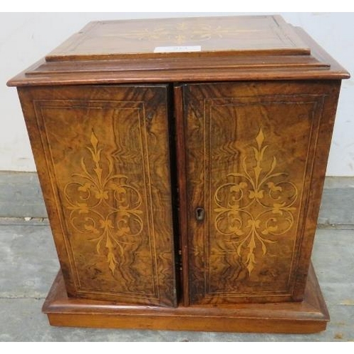 853 - A Victorian figured walnut and mahogany tabletop cabinet, having marquetry inlay, the twin doors ope... 