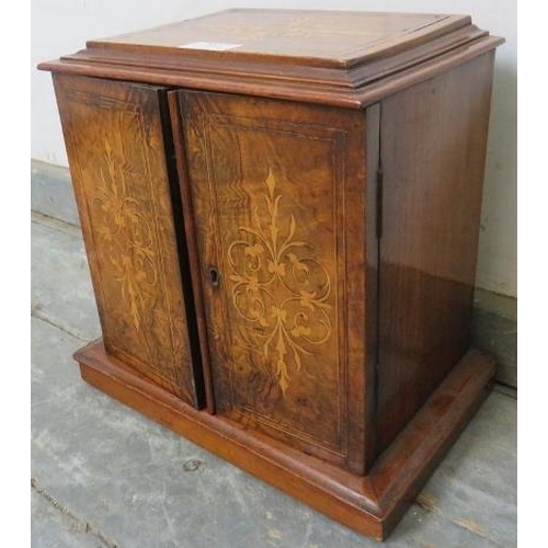 853 - A Victorian figured walnut and mahogany tabletop cabinet, having marquetry inlay, the twin doors ope... 