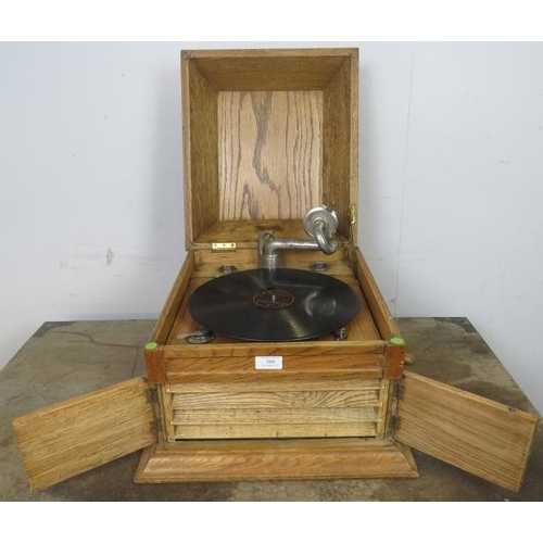 860 - An early 20th century light oak cased tabletop gramophone by Karna, together with approximately 50 r... 