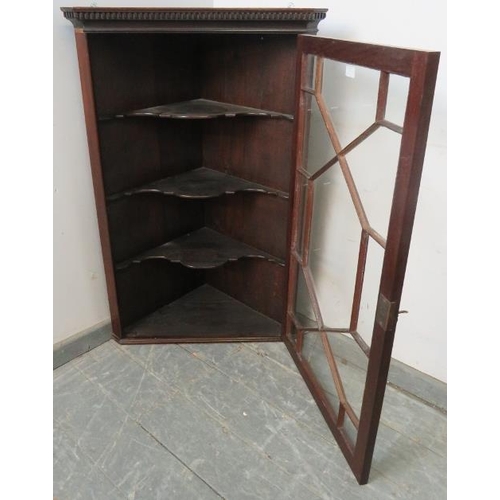 870 - A Georgian mahogany glazed corner cupboard, with dentil cornice, the astral glazed door opening onto... 