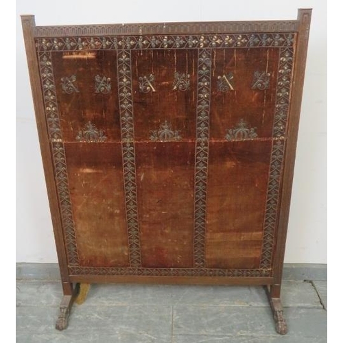 873 - A large 19th century mahogany firescreen, with chip carved frieze, the antique velvet panel with rep... 