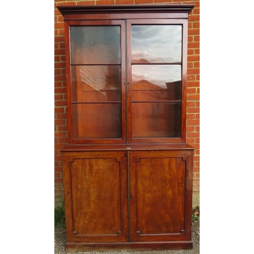 882 - A large 19th century mahogany glazed bookcase of good colour, the top section with stepped cornice a... 