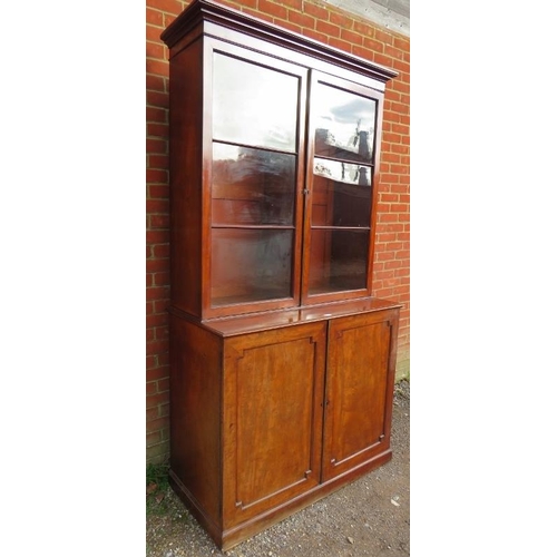 882 - A large 19th century mahogany glazed bookcase of good colour, the top section with stepped cornice a... 