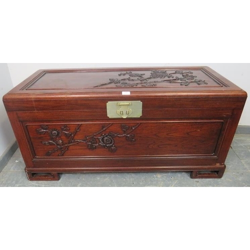 883 - A vintage Chinese export camphor wood trunk, having relief carved decoration depicting prunus blosso... 