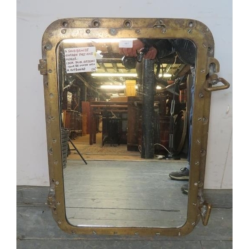 887 - An antique solid bronze ship’s porthole, converted into a wall mirror. The fastening dogs still func... 