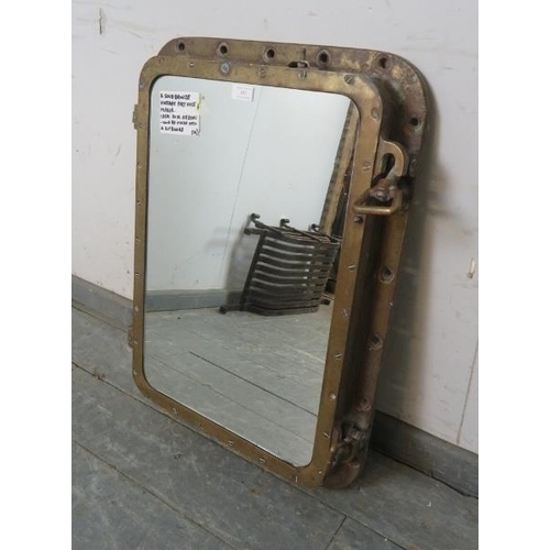 887 - An antique solid bronze ship’s porthole, converted into a wall mirror. The fastening dogs still func... 