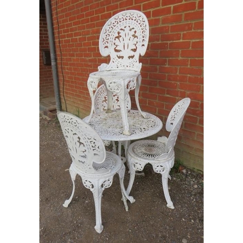 888 - A vintage Victorian style garden set painted white, comprising a circular table and four chairs, wit... 