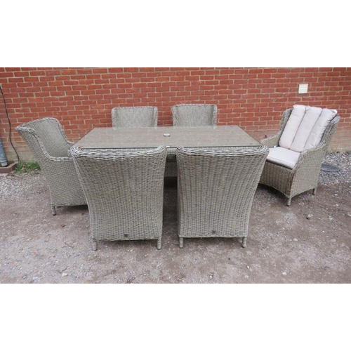 890 - A good quality wicker garden set by LG Outdoor, comprising a glass-topped table and six armchairs, a... 