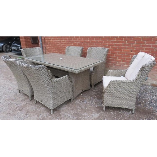 890 - A good quality wicker garden set by LG Outdoor, comprising a glass-topped table and six armchairs, a... 