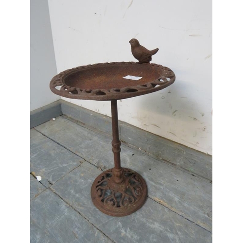 892 - A small cast iron bird bath, with figural garden bird to rim and pierced and scrolled decoration, on... 