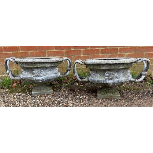 894 - A pair of vintage lead urns/garden planters in the 18th century taste, having relief moulded decorat... 