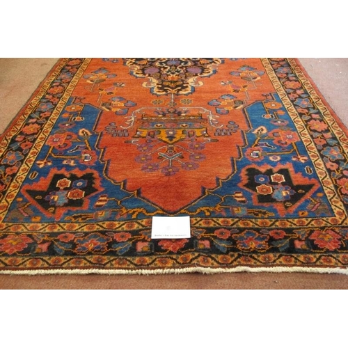 906 - A North West Persian Malayer rug, central Medallion on salmon ground. 240cm x 135cm.
Condition repor... 