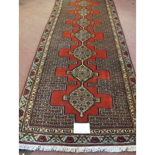 908 - A North West Persian Senneh runner, thick weave with a central repeat pattern, 305 cm x 90cm.
Condit... 