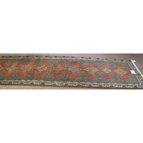 908 - A North West Persian Senneh runner, thick weave with a central repeat pattern, 305 cm x 90cm.
Condit... 