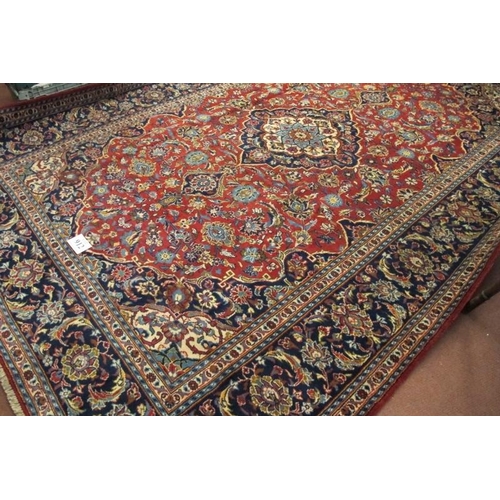 912 - A good central Persian Kashan carpet central motif blue/cream on a floral red ground, with very wide... 