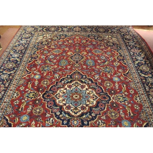 912 - A good central Persian Kashan carpet central motif blue/cream on a floral red ground, with very wide... 