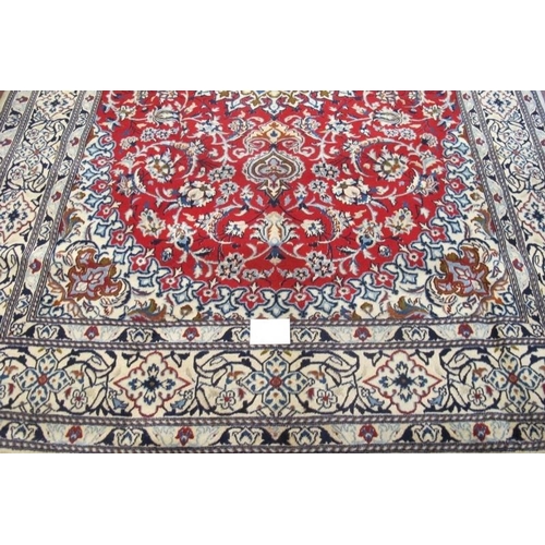 913 - A Persian rung, central motif on red ground and wide blue & cream borders. Very clean rug. 294cm x 2... 