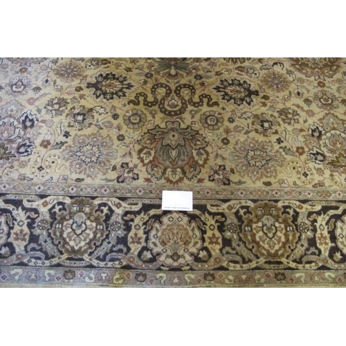 914 - A late 20th century Indian pure wool carpet. Central block pattern of foliage on a deep cream ground... 