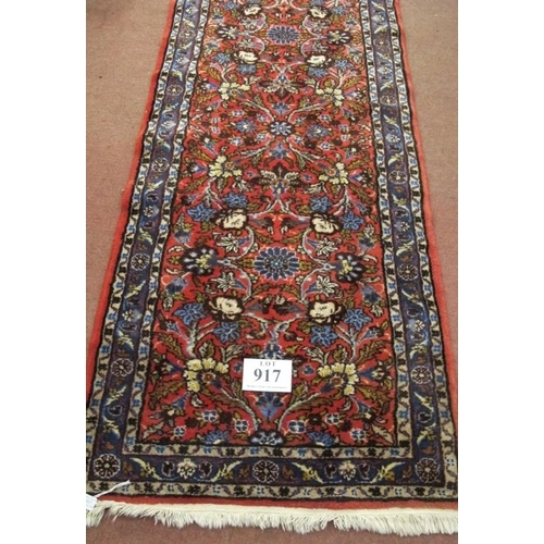 917 - A 20th century Persian runner central, floral pattern  on red ground. In good clean condition. .81 x... 