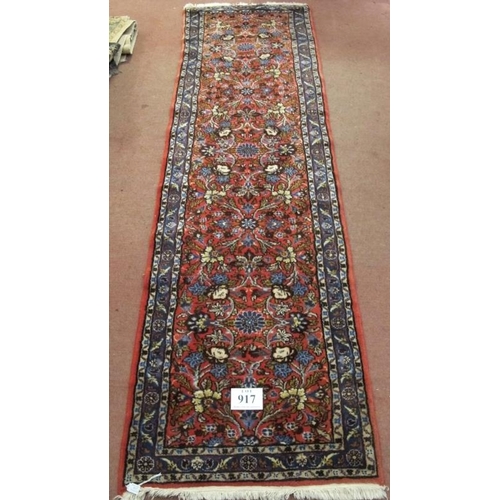 917 - A 20th century Persian runner central, floral pattern  on red ground. In good clean condition. .81 x... 