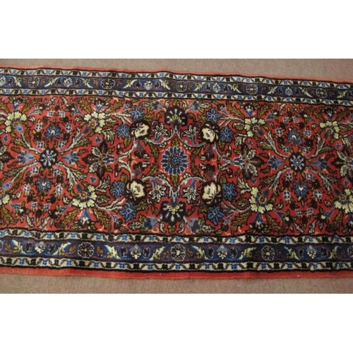 917 - A 20th century Persian runner central, floral pattern  on red ground. In good clean condition. .81 x... 