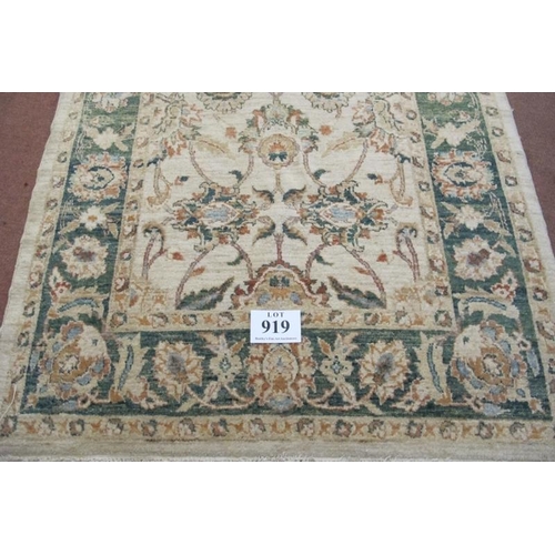 919 - A late 20th century wool rug. Flower design, green on cream ground, nice rug. Good clean condition. ... 