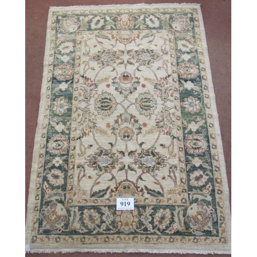 919 - A late 20th century wool rug. Flower design, green on cream ground, nice rug. Good clean condition. ... 