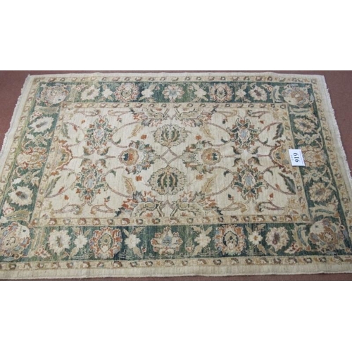 919 - A late 20th century wool rug. Flower design, green on cream ground, nice rug. Good clean condition. ... 