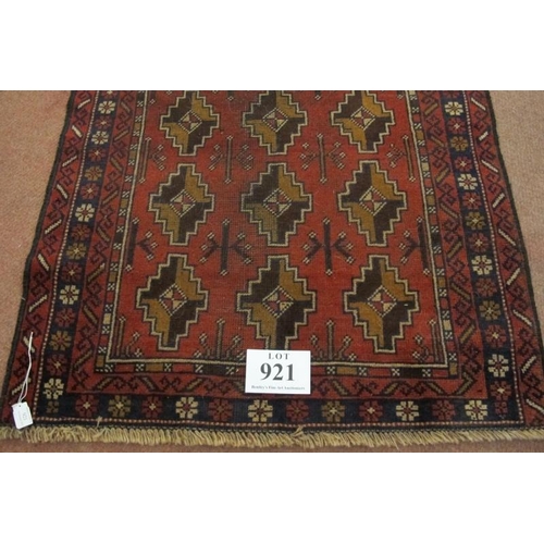 921 - A mid 20th century Persian rug, repeat central pattern on red ground. Slight colour variation. See i... 