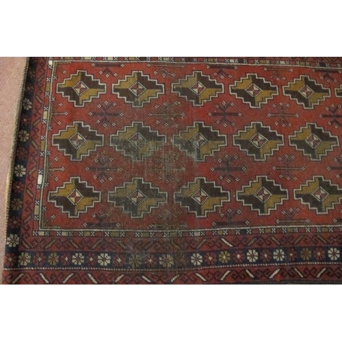 921 - A mid 20th century Persian rug, repeat central pattern on red ground. Slight colour variation. See i... 