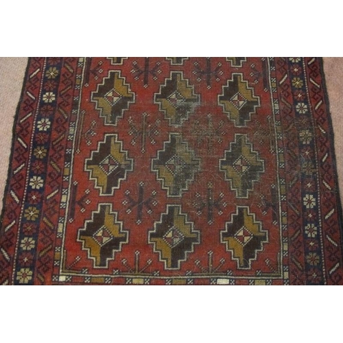 921 - A mid 20th century Persian rug, repeat central pattern on red ground. Slight colour variation. See i... 