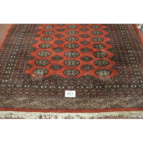 923 - A mid-late 20th century Persian carpet. Central block repeat pattern on red ground, with an extra wi... 