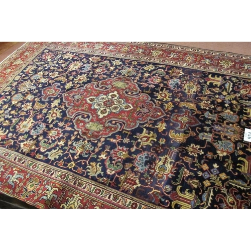 924 - A fine Persian Tabriz carpet. Central medallion, red on blue ground, deep borders and in excellent c... 