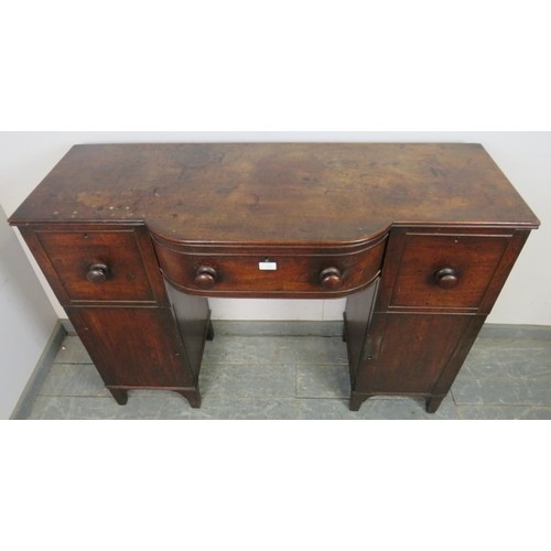 746 - A Regency Period mahogany pedestal sideboard of small proportions, having a reeded edge above bow-fr... 