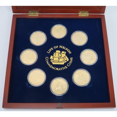 123 - A Life of Nelson Commemorative Coins Set. Eight gilt metal one dollar coins housed in a matching dis... 