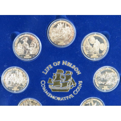 123 - A Life of Nelson Commemorative Coins Set. Eight gilt metal one dollar coins housed in a matching dis... 