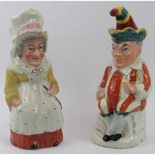 142 - A large pair of rare Staffordshire Punch and Judy jugs with covers. (2 items) 29.5 cm height. 
Condi... 