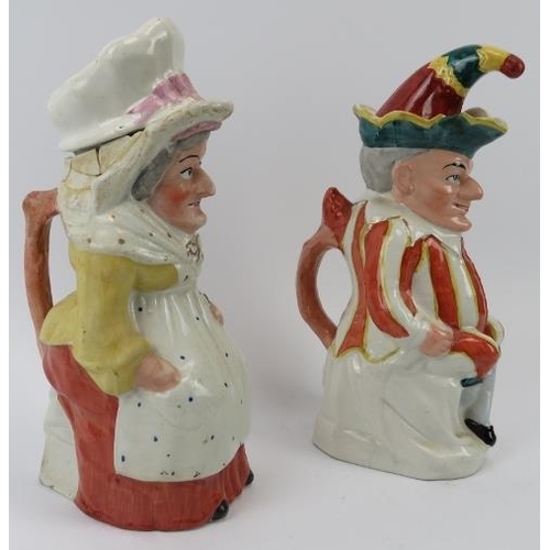 142 - A large pair of rare Staffordshire Punch and Judy jugs with covers. (2 items) 29.5 cm height. 
Condi... 