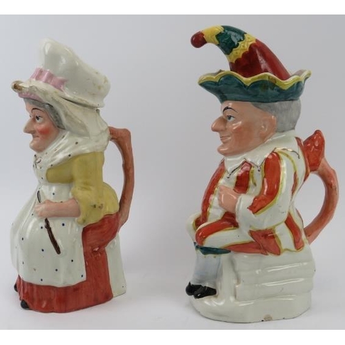 142 - A large pair of rare Staffordshire Punch and Judy jugs with covers. (2 items) 29.5 cm height. 
Condi... 