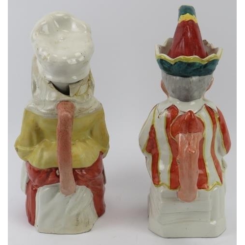 142 - A large pair of rare Staffordshire Punch and Judy jugs with covers. (2 items) 29.5 cm height. 
Condi... 