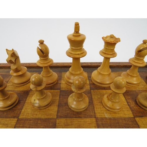 154 - A vintage turned and ebonised holly wood chess set and a stained oak chessboard, mid/late 20th centu... 