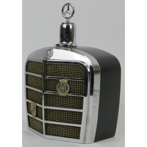 159 - Automobilia: A vintage Mercedes Benz car grill drinks decanter flask and two car bonnet emblems, mid... 